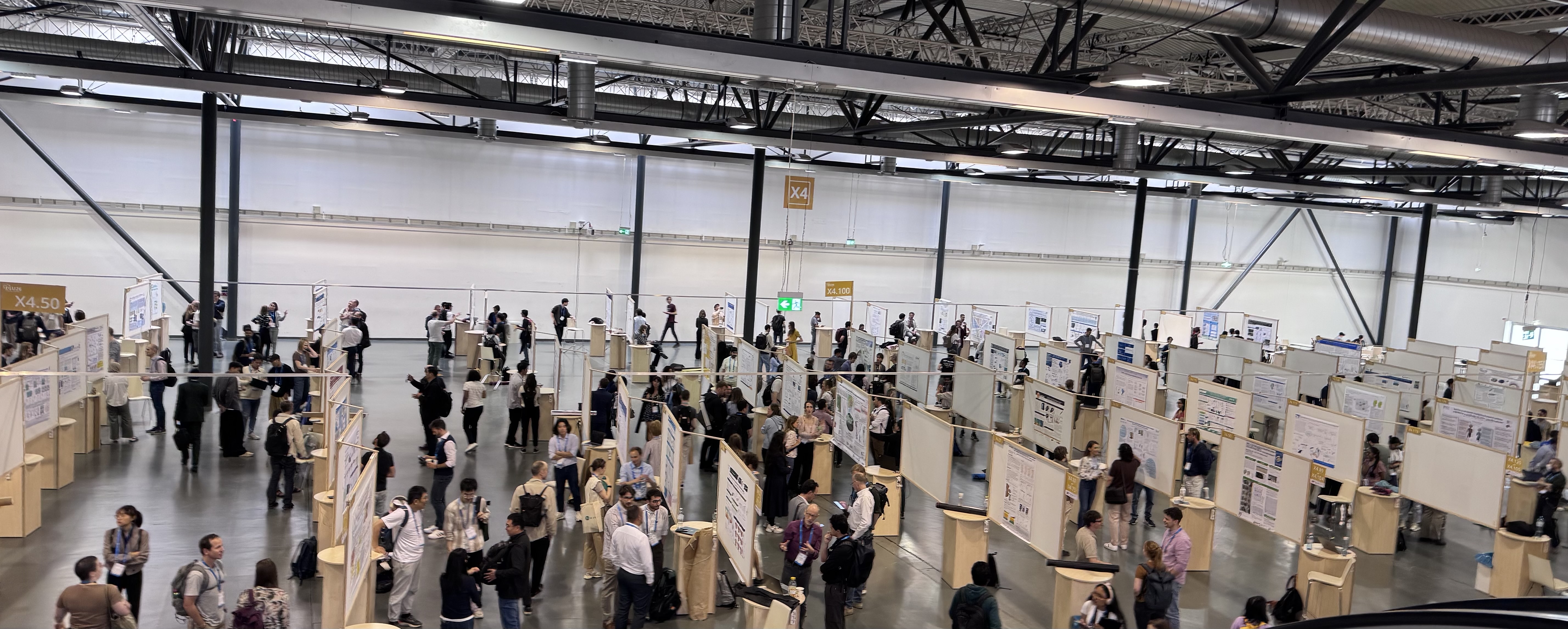 A view of a poster hall, high ceiling, lots of people